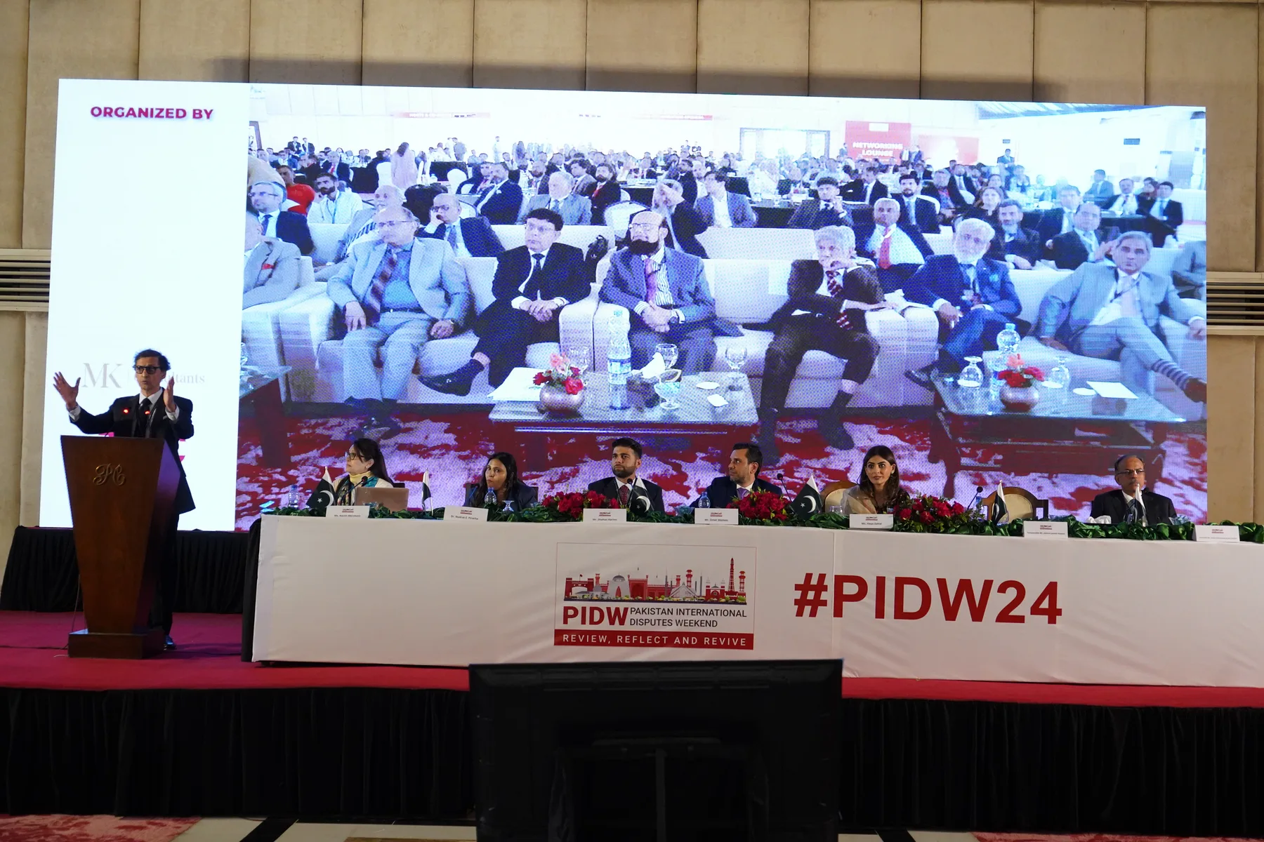 A judicial keynote on stage at PIDW24 in Karachi.